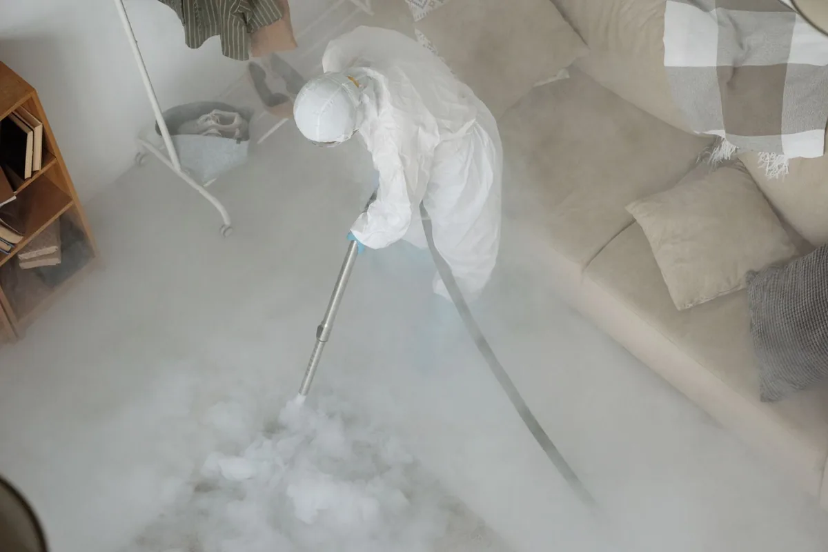 Biohazard cleanup technician in protective equipment, Hooverson Heights, WV